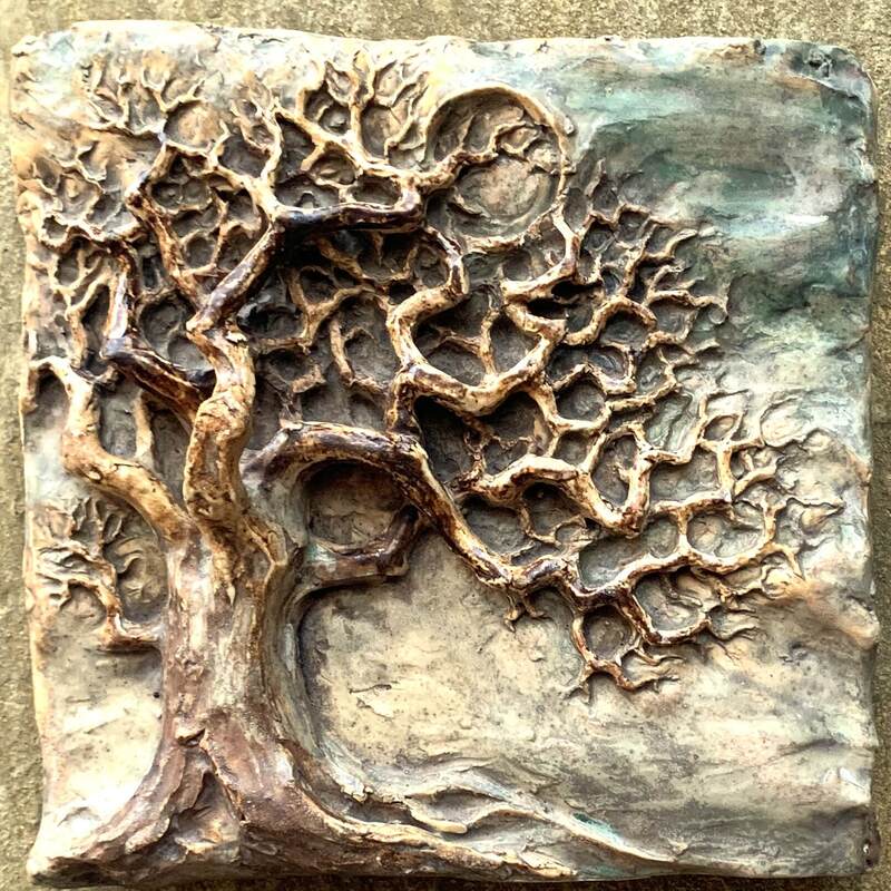ceramic tile with a relief sculpture of a tree